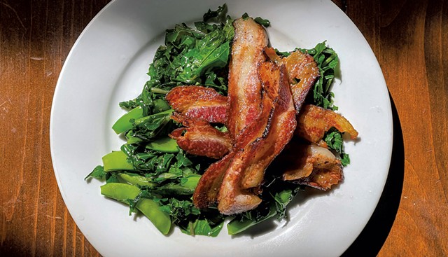 Libbey's housemade bacon on a bed of greens - SUZANNE PODHAIZER