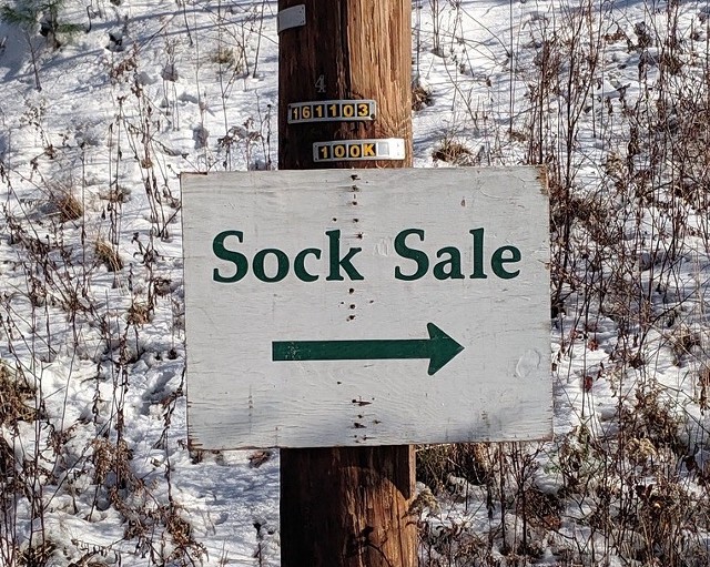 A sign pointing the way to a Darn Tough sock sale in the past. - COURTESY