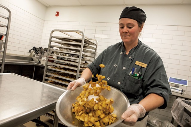 Melissa Mayo prepping home fries at UVM's Central Campus Dining hall - LUKE AWTRY