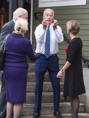 Vice President Joe Biden holds up coins he found outside Penny Cluse Café Friday morning in Burlington. - POOL: GLENN RUSSELL/BURLINGTON FREE PRESS