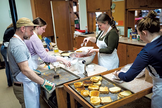 From left: Teacher Josh Fox and students Ella Considine, Lily Castle and Maverick Murphy packing to-go meals at the United Church of Hardwick - JOSH KUCKENS