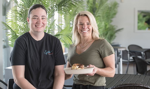Kitchen manager Amanda Lawlor, left, and owner Jenn Sinclair with a breakfast burger - DARIA BISHOP