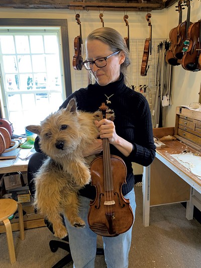 Danielson with her Norwich terrier, Bromley, and a handmade violin - AMY LILLY