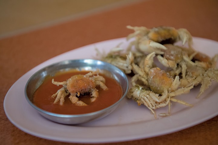 Fried crabs dunked in housemade Sriracha at Pichai - DARIA BISHOP
