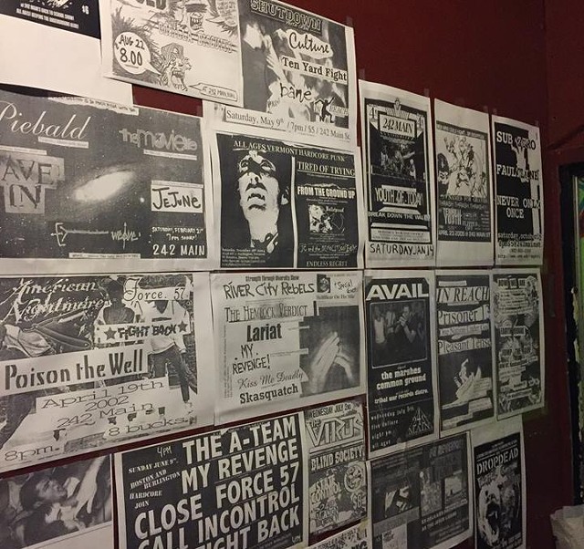 An archive of past flyers hang on the walls of 242 for its farewell show. - 242 MAIN