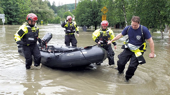 A swift-water rescue team from New York returning from a call for assistance in Montpelier on Tuesday - KEVIN MCCALLUM ©️ SEVEN DAYS