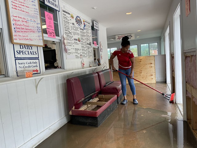 Server Melisa Simpson pushing water out the door last Thursday - MARY ANN LICKTEIG