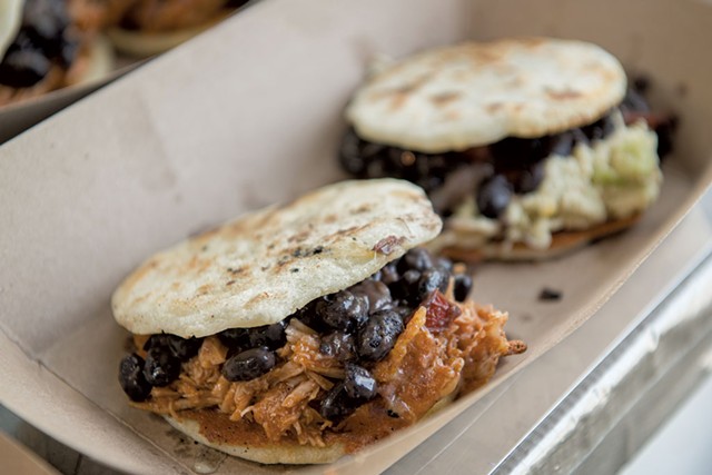 A BBQ pulled pork arepa with beans (left) and a chicken arepa - DARIA BISHOP