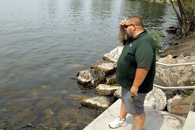 Burlington beach manager Alec Kaeding looking for blue-green algae - COURTNEY LAMDIN ©️ SEVEN DAYS
