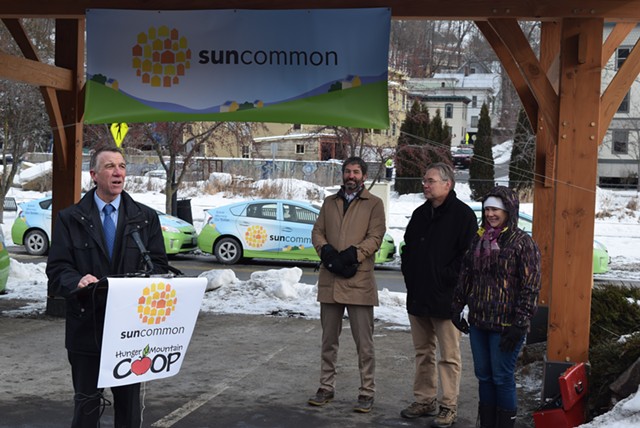 Gov. Phil Scott (left) joins SunCommon cofounder (second from left) James Moore at a press conference Monday. - TERRI HALLENBECK