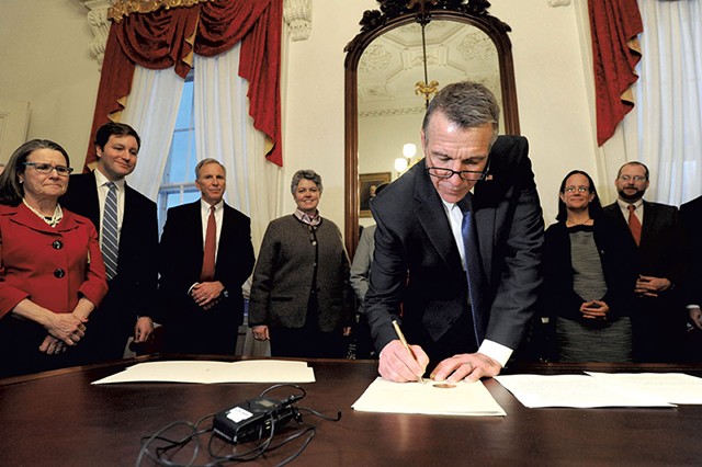 Gov. Phil Scott signing an executive order calling on state government to make Vermont more "affordable" - JEB WALLACE-BRODEUR