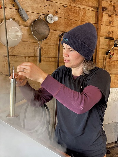 Marina Wood-McNaughton checking the boiled cider - COURTESY OF ZACHARY MCNAUGHTON