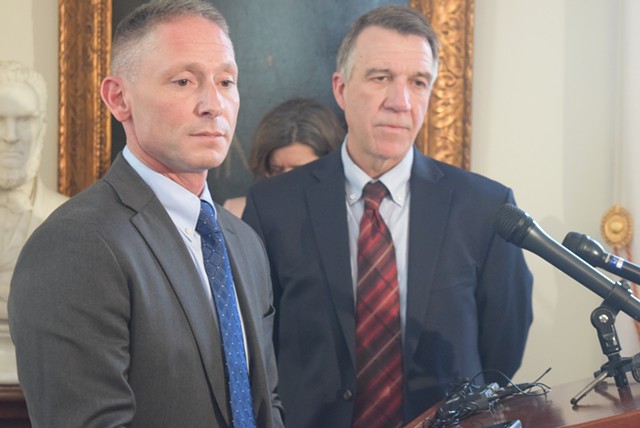 Commerce Secretary Michael Schirling (left) and Gov. Phil Scott talk Tuesday about the proposed agency reorganization.