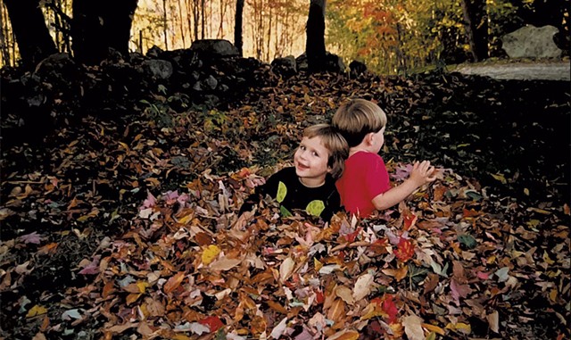 Nicole and her brother playing in the leaves - COURTESY