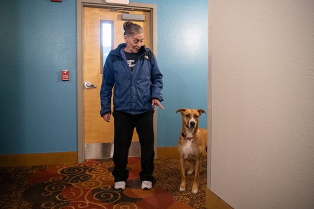 Mary Mojica and her dog, Bella, outside their room at the Days Inn in Colchester - DARIA BISHOP