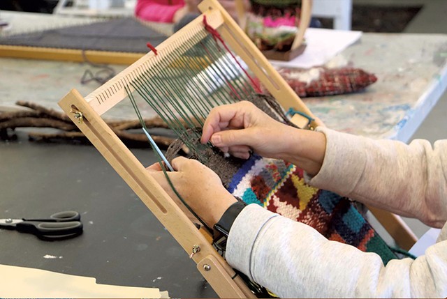 A student weaving - COURTESY