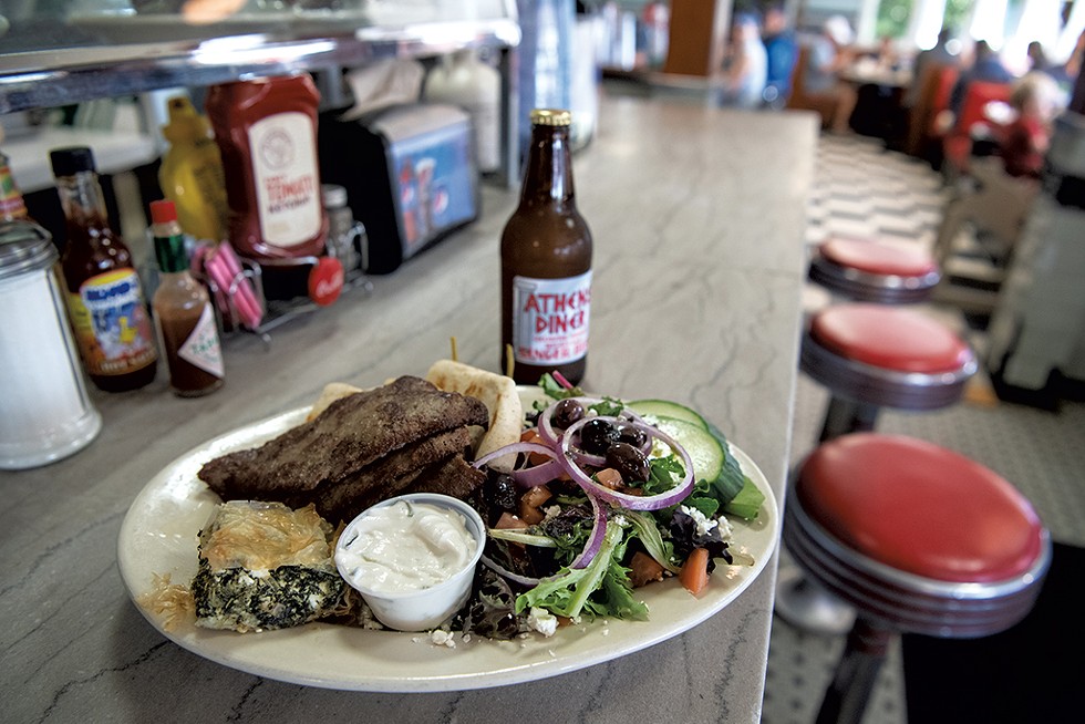 Lamb platter with spanakopita, tzatziki sauce and a Greek salad - DARIA BISHOP