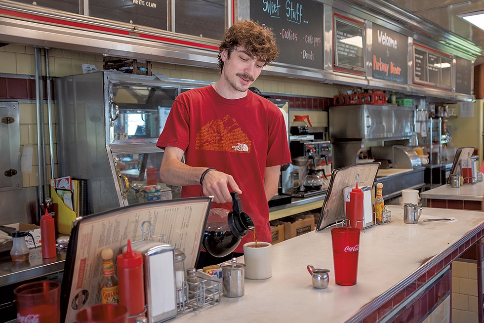 Waiter River Collins pouring coffee - JORDAN BARRY ©️ SEVEN DAYS