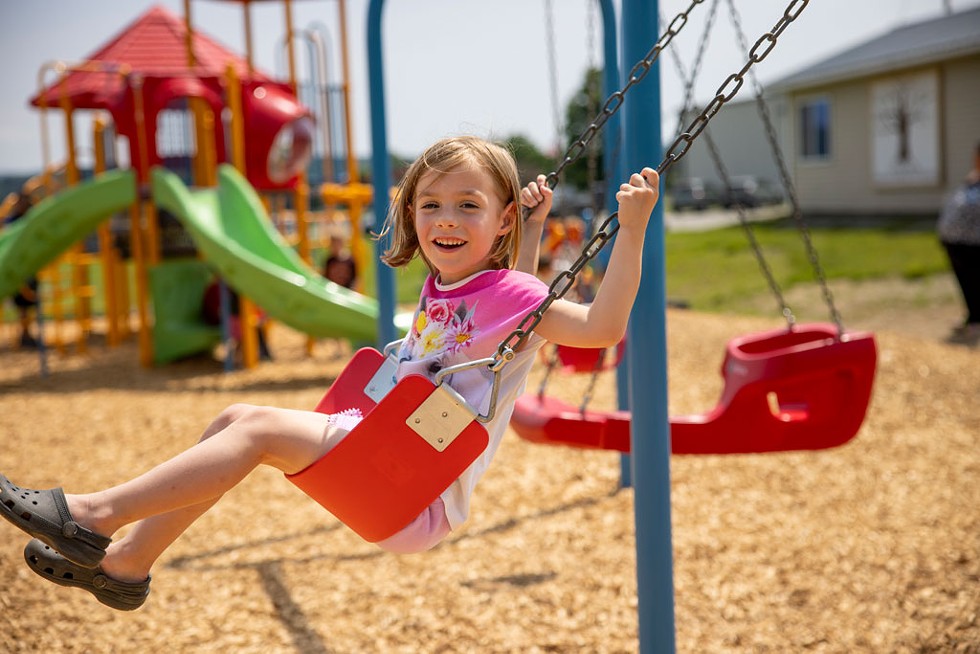 A kid enjoying the swing set at the new Enosburgh Community Playground - JAMES BUCK