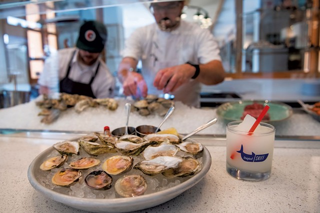 Oysters and littleneck clams with a frozen gin and tonic at the raw bar at Original Skiff Fish + Oysters - DARIA BISHOP