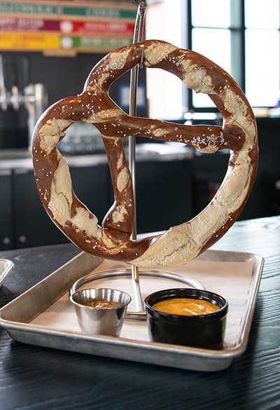 Jumbo soft pretzel with housemade mustard and Karsten Premium Lager-infused Cabot cheddar sauce - DARIA BISHOP