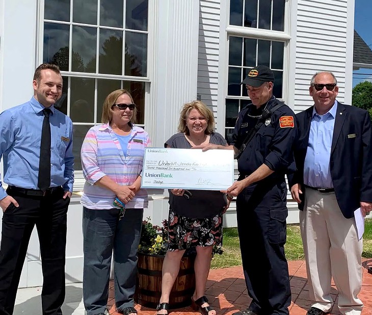 A Union Bank team presenting a check to the Underhill Jericho Fire Department at the grand opening of the bank’s Jericho branch - COURTESY