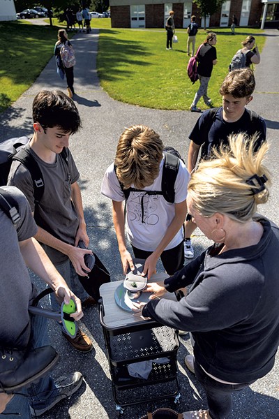 Unlocking cellphone pouches with the Yondr system at Thetford Academy - ROB STRONG