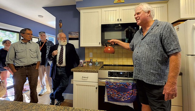 John Snell describing his new induction stove at an event highlighting energy efficiency - KEVIN MCCALLUM ©️ SEVEN DAYS