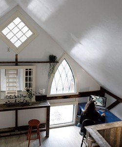The arched windows in Hopkins' converted barn home were salvaged from the church across the street - SARAH PRIESTAP
