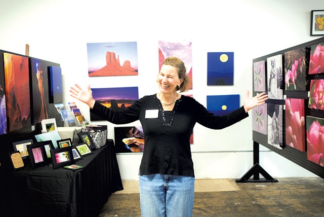 Trine Wilson, a member of the Milton Artists' Guild, standing in her gallery booth - TIMOTHY SANTIMORE