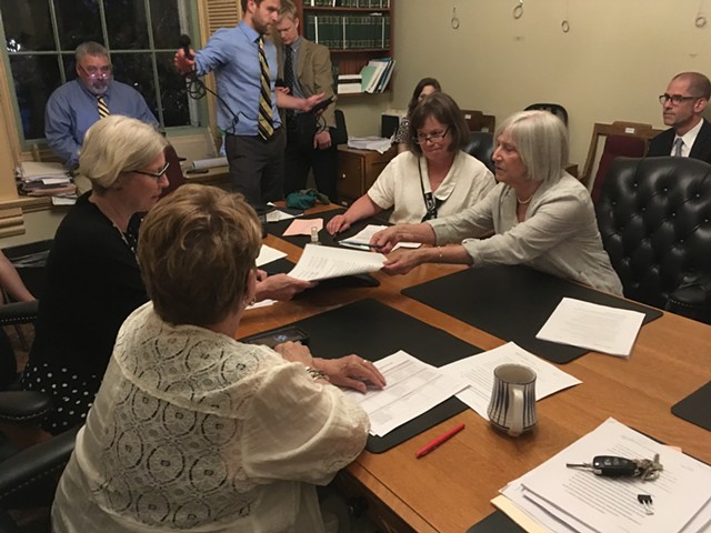 Legislative negotiators sign off on an education tax bill late Thursday at the Vermont Statehouse. - TERRI HALLENBECK