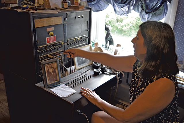 Franklin Telephone manager Kim Gates - showing off the company’s antique equipment - TERRI HALLENBECK