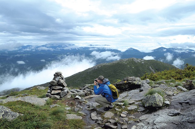 Steve Humphry taking a photo on Algonquin Peak - SASHA GOLDSTEIN