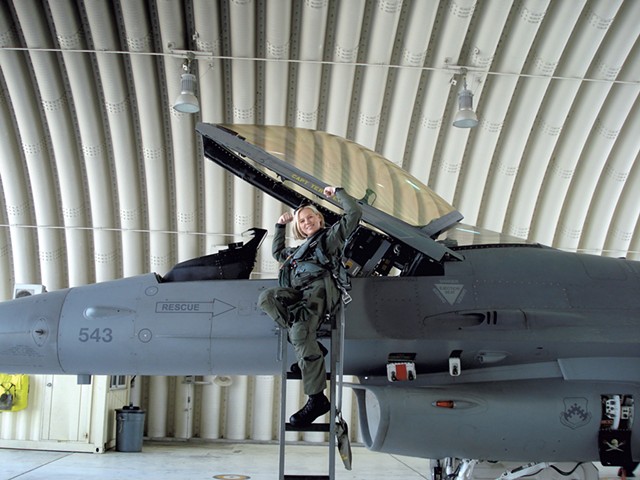 Major Sherry with her F-16 in South Korea, demonstrating a common greeting among fighter pilots - COURTESY OF TERRY SHERRY