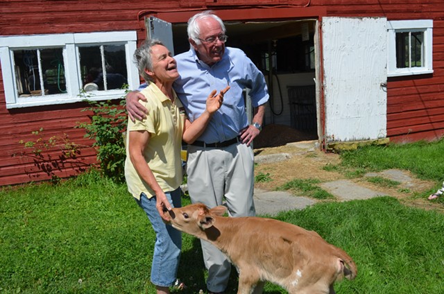Sanders stands with Linda Stanley and her newborn calf. - ALICIA FREESE
