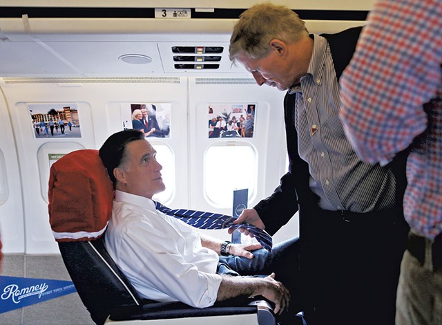Mitt Romney (left) and Stuart Stevens talking aboard the Romney campaign plane in October 2012 - AP PHOTO/CHARLES DHARAPAK