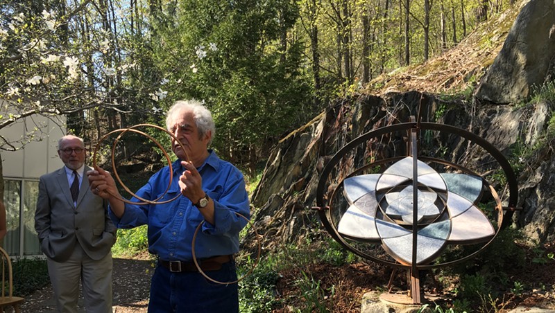 Paul Calter, right, with his sculpture "Trillium" as  state curator David Schütz looks on.