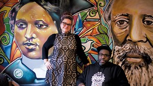 Jennifer Herrera Condry and Will "KASSO" Condry in front of a mural depicting Mary Annette Anderson and Martin Henry Freeman