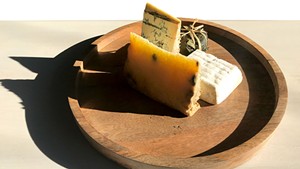 Piedmont and Lombardy cheese board at Dedalus Wine Shop: Robiola Tre Latti Fico (in leaf), Bergamino di Bufala (white square), Castelmagno d'Alpeggio (golden), Blu Imperiale (blue)
