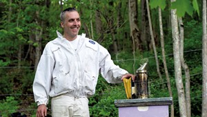 David Tremblay with a hive in Montpelier