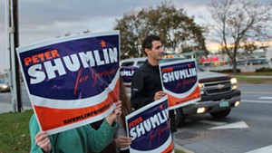 Gov. Peter Shumlin's supporters hold signs outside an October 2014 debate.