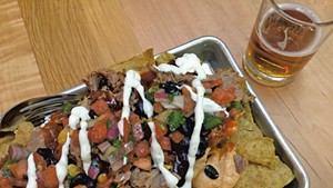 Hickory-smoked pork nachos and beer at the Otter Creek Brewing pub