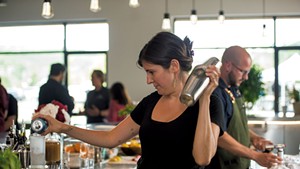 Bartender Emma Sanford and beverage director Sam Nelis preparing cocktails at Caledonia Spirits