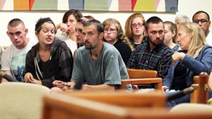 Desiree Herring and Felicia Kennison, center of front row, at their mother's arraignment Monday