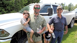 Kurt Magnan, his two kids and his father, Jim Magnan, after the merger vote