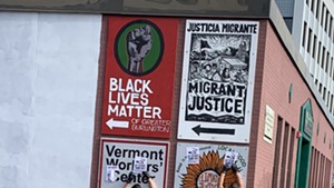 Burlington officers removing stickers from a hate group Wednesday