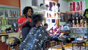 Mistre Newton gets her hair done at Burlington's Diversity Hair Salon.