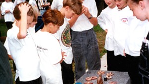 Children look at their artworks to be buried under "Zig Zag" in 1994