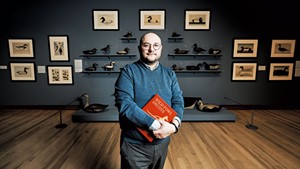 Kory Rogers standing in front of the "Joel Barber &amp; the Modern Decoy" exhibit