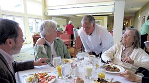 Bill Koucky visiting with residents in the dining room
